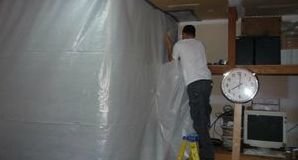 Water and Mold Damage Restoration Tech Installing A Vapor Barrier