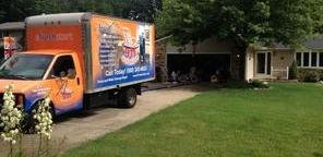 Water Damage and Mold Restoration Truck Parked Near Lawn