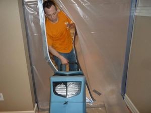 Water Damage Enfield Technician Using Air Mover Near Vapor Barrier