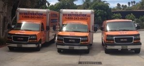 Water Damage Restoration Van And Trucks At Commerical Job Location